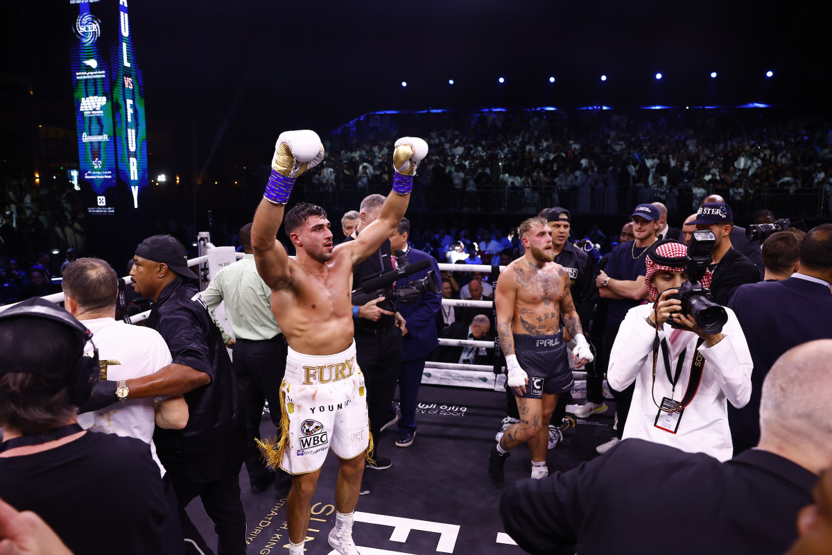 Tommy Fury stands in the ring with his fists in the air